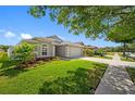 Landscaped front yard of a well-maintained home with a charming garden and a two-car garage at 19309 Garden Quilt Cir, Lutz, FL 33558
