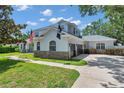 Beautiful home featuring an attached three car garage, well maintained lawn, and stone accents at 2011 Water Wheel Ct, Dunedin, FL 34698