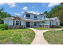 Charming home with stone accents, lush lawn, and welcoming walkway leading to the front door at 2011 Water Wheel Ct, Dunedin, FL 34698