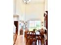 Inviting dining room with high ceilings, a wooden dining set, and ample natural light from a large window at 2130 Broadway View Ave, Brandon, FL 33510