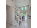Bright and airy living room with staircase and views of the pool at 2424 Caraway Dr, Venice, FL 34292