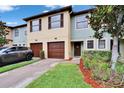 Charming townhome boasts colorful exterior, attached single-car garage, and a well-maintained lawn at 2435 Edgewater Falls Dr, Brandon, FL 33511