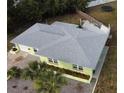 Aerial view of the home showcasing the roof, landscaping, fenced in backyard, and patio at 2444 35Th N St, St Petersburg, FL 33713