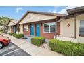 Charming exterior showing colorful doors, brickwork, and well-maintained landscaping at 24862 Us Highway 19 N # 1105, Clearwater, FL 33763