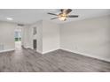 Bright living room featuring modern flooring, ceiling fan and neutral paint palette at 24862 Us Highway 19 N # 1105, Clearwater, FL 33763