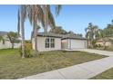 Charming single story home featuring a two car garage, neutral paint and mature trees at 3058 Cara Ct, Palm Harbor, FL 34684