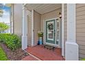 Welcoming front entrance with a brick walkway, green door, and decorative plants at 311 1St Sw Ave, Largo, FL 33770