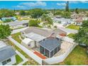 Aerial view of fenced backyard featuring a screened-in patio, shed and open-air patio at 3145 Domino Dr, Holiday, FL 34691