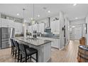 Modern kitchen featuring stainless steel appliances, granite countertops, and a large center island at 31921 Magna Gulf Loop, San Antonio, FL 33576