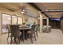 Inviting screened-in patio with ample seating and ceiling fans, perfect for entertaining or relaxing at 31921 Magna Gulf Loop, San Antonio, FL 33576