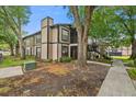 Charming condo with lush landscaping, mature trees, and visible stairway access at 4004 Dream Oak Pl # 102, Tampa, FL 33613