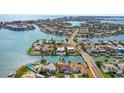 Panoramic aerial showcasing the waterfront community with numerous canals, homes, and stunning views of the open ocean at 403 Normandy Rd, Madeira Beach, FL 33708