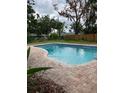 Sparkling in-ground swimming pool with a brick surround in a fenced backyard at 5281 Venetian Ne Blvd, St Petersburg, FL 33703