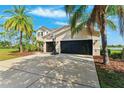 Lovely home with a large driveway, three-car garage, basketball hoop, and surrounded by lush landscaping at 5457 Sandy Shell Dr, Apollo Beach, FL 33572