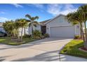 Charming single-story home with lush landscaping, a two-car garage and a welcoming screened front porch at 6211 114Th E Dr, Parrish, FL 34219