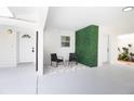 Inviting covered patio with stylish seating and a modern green wall feature at 6304 Memorial Hwy, Tampa, FL 33615