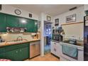 Functional kitchen boasts stainless steel appliances, practical cabinets, and tiled floor at 6401 15Th N St, St Petersburg, FL 33702