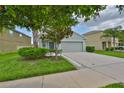 Charming single-Gathering home with a well-maintained lawn and a two-car garage at 6512 Trent Creek Dr, Sun City Center, FL 33573
