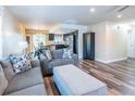 Comfortable living room featuring new flooring, gray sofa, and seamless flow to the open kitchen and dining area for easy living at 7065 73Rd N St, Pinellas Park, FL 33781