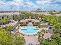 Resort-style community pool and lounge area surrounded by lush landscaping and seating at 741 Mainsail Dr, Tampa, FL 33602