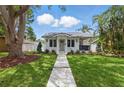 Charming home featuring a well-manicured lawn, fresh landscaping, and a welcoming walkway to the front door at 791 44Th N Ave, St Petersburg, FL 33703