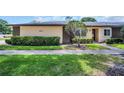 Inviting single story home with meticulously maintained landscaping, sidewalk, and a well-kept lawn at 860 Maclaren N Dr # A, Palm Harbor, FL 34684