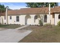 Charming townhouse featuring an arched entryway, fresh landscaping, and a spacious driveway at 9831 83Rd Way, Seminole, FL 33777