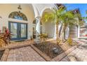 Inviting front entrance with double doors, decorative columns, and a brick-paved walkway at 10724 Cory Lake Dr, Tampa, FL 33647