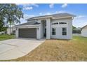 Charming two-story home with a well-kept lawn, features a two-car garage and inviting front entrance at 12102 Steppingstone Blvd, Tampa, FL 33635