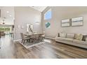 Bright living room with hardwood floors, dining table, a high ceiling, and natural light at 12102 Steppingstone Blvd, Tampa, FL 33635