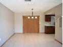 Dining room features neutral colors and tile flooring next to the kitchen at 12488 Harper St, Spring Hill, FL 34609