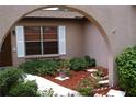 Home entrance featuring a landscaped courtyard and a decorative archway at 12488 Harper St, Spring Hill, FL 34609