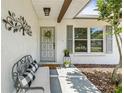 Inviting front porch with comfortable seating and decorative accents at 1410 Brighton Ct, Palm Harbor, FL 34684