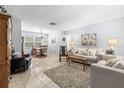 Spacious living room featuring tile floors, neutral tones, and stylish decor at 1410 Brighton Ct, Palm Harbor, FL 34684