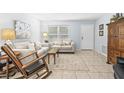 Bright living room showcasing tile floors and comfortable seating at 1410 Brighton Ct, Palm Harbor, FL 34684