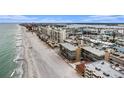 Aerial view of condo building, beach and ocean in an attractive coastal setting at 14900 Gulf Blvd # 308, Madeira Beach, FL 33708