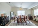 Comfortable dining room with a stylish rug, dark wood floors, and neutral paint at 1512 56Th N Ave, St Petersburg, FL 33703