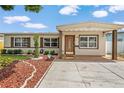 Well-maintained single-story home with mature landscaping and a covered front porch at 1512 56Th N Ave, St Petersburg, FL 33703