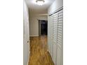 Hallway showcasing wood flooring and a closet offering ample storage space inside the townhouse at 1515 Bayshore Blvd # 38, Dunedin, FL 34698