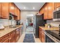Kitchen area with wooden cabinets and stainless steel appliances at 1515 Bayshore Blvd # 38, Dunedin, FL 34698