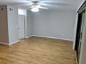 Spacious living room with wood floors, a ceiling fan, and sliding glass doors at 1515 Bayshore Blvd # 38, Dunedin, FL 34698