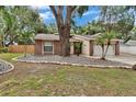 Single-story home with brick accents, mature trees and established landscaping at 1613 Long Pond Dr, Valrico, FL 33594