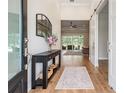 Inviting foyer with stylish console table and view into the spacious living area at 17566 Hyland Ln, Dade City, FL 33523