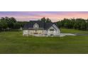 Beautiful modern farmhouse-style home with black accents, large front yard, and covered porch at 17566 Hyland Ln, Dade City, FL 33523