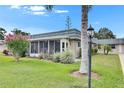 Beautiful exterior showcasing lush landscaping, a screened lanai, and a peaceful outdoor setting at 1802 Bedford Ter # 185, Sun City Center, FL 33573