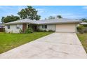 View of home showcasing the driveway leading to an attached two car garage at 1813 Lakeview Dr, Brandon, FL 33511