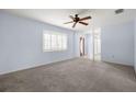 Spacious living room boasts neutral carpet, ceiling fan and plantation shutters at 1813 Lakeview Dr, Brandon, FL 33511