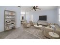 Spacious living room with neutral carpet, ceiling fan, and lots of natural light at 1813 Lakeview Dr, Brandon, FL 33511