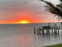 Wonderful sunrise view over the ocean with a silhouette of a private dock in the foreground at 1967 Brightwaters Ne Blvd, St Petersburg, FL 33704