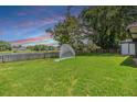 Lush green backyard with a view of the serene lake at 2016 Chelam Way, Brandon, FL 33511